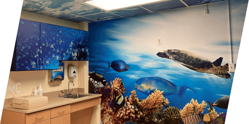 A bathroom showcasing a beautiful ocean scene mural, providing a calming ambiance with its artistic wall wrap design.